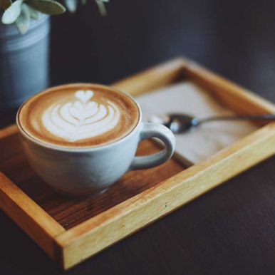 cup of coffee latte art in coffee shop vintage color tone