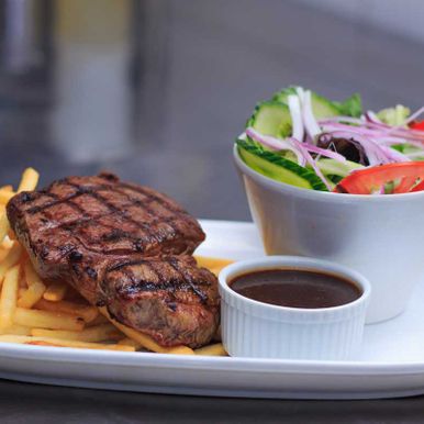 Grass Fed Rump Steak with Salad, Chips and pepper sauce is ready to serve at australian pub bistro, restaurant